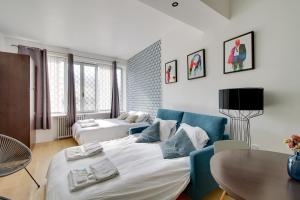 a living room with a large bed and a table at 176 Suite Jean - Superb apartment in Paris in Paris