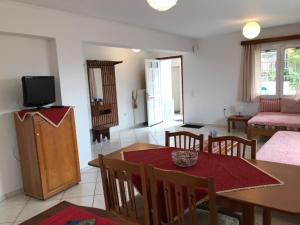 a living room with a dining table and a television at MARINA's HOME in Konitsa