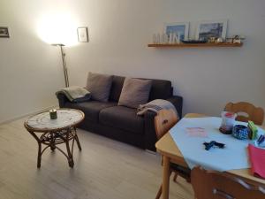 a living room with a couch and a table at Strandperle in Westerland