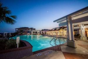 a large swimming pool in the middle of a building at Pharoah's Palace at Pointe West Resort in Galveston