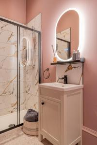 a bathroom with a sink and a shower at Boutique Home Stay Blossom in Paisley