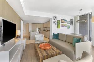 a living room with a couch and a table at Ocean View Balcony with Pool Gym Access in Hallandale Beach
