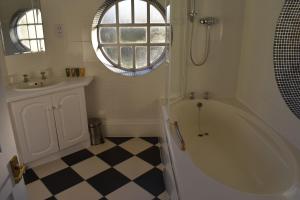 a white bathroom with a tub and a sink at Botleigh Grange Hotel in Southampton +33 photos