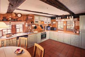 a kitchen with white cabinets and a table and chairs at Vogtshof Rottweil 