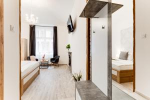 a living room with a mirror and a bed at Dream Apartments Prague in Prague