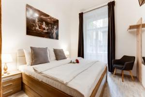 a bedroom with a large bed and a chair at Dream Apartments Prague in Prague