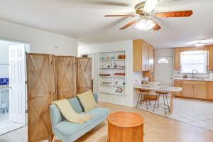 a living room with a blue chair and a kitchen at Peaceful Albany Vacation Rental about 6 Mi to Downtown in Albany