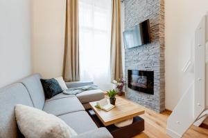 a living room with a couch and a fireplace at Dream Apartments Prague in Prague
