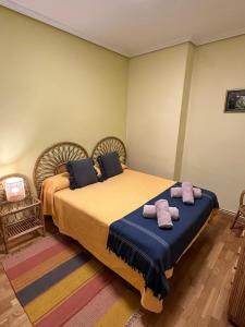 a bedroom with two beds with purple towels on them at Casa de pueblo con merendero y chimenea. in Viguera