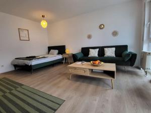 a living room with a couch and a table at Studio-Priv.Parkplatz-Balkon-Wlan-Netflix-SmartTV in Deizisau