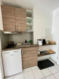 a small kitchen with a sink and a refrigerator at Studio-Priv.Parkplatz-Balkon-Wlan-Netflix-SmartTV in Deizisau