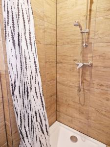 een douche met een zwart-wit douchegordijn bij City Apartment in Bremerhaven
