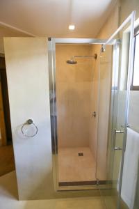 a shower with a glass door in a bathroom at Villa Voilier in Mahe