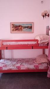 two bunk beds in a room with a picture on the wall at Salta Paradise in San Bernardo