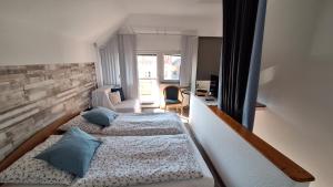 a bedroom with two beds and a window at FOKI Apartman in Siófok