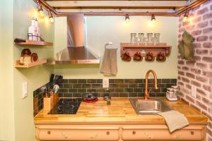 a kitchen with a sink and a counter at Miami Tiny Vintage Cottage in Hialeah