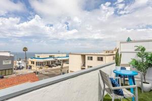 a balcony with a blue table and a chair at AMAZING OCEAN VIEW - LUXURY Manhattan Beach 1 Bedroom - Parking in Manhattan Beach