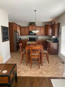 a kitchen with a wooden table and chairs and a table and a kitchen with at Davidson House - 3 beds 2.5 baths in Davidson