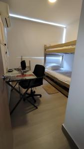 a small room with a desk and a bed at Apartment In North Of The City Barranquilla in Barranquilla