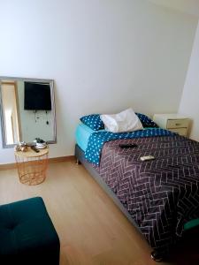 a bedroom with a bed and a television in it at Apartment In North Of The City Barranquilla in Barranquilla