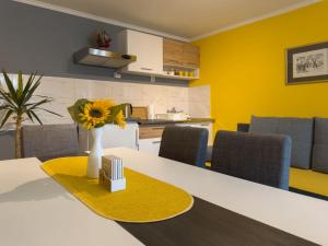 a dining room with a table with a vase of flowers at HILL 2 in Golubac