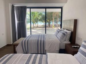 מיטה או מיטות בחדר ב-Villas del Mar