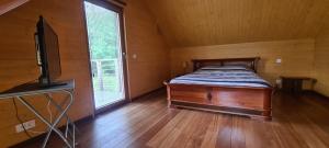 ein Schlafzimmer mit einem Bett und einem TV in einem Zimmer in der Unterkunft L'atelier in Soucelles