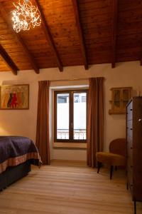 Schlafzimmer mit einem Bett und einem Fenster in der Unterkunft La Sorpresa - luxury apartment in historic city center in Arona