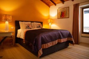 a bedroom with a large bed with two lamps at La Sorpresa - luxury apartment in historic city center in Arona
