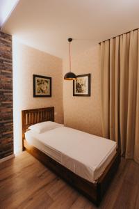 a bedroom with a bed and a pendant light at Tirana Resort Radhime in Radhimë