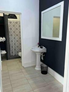 a bathroom with a sink and a mirror at Southsea Seniors Retirement Resort & Villa in Kings Pen