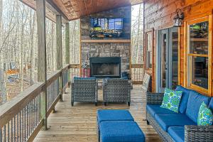 a porch with a couch and chairs and a fireplace at Black Bearry in Blue Ridge