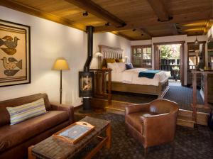 a bedroom with a bed and a couch and a chair at Rancho Caymus Inn in Rutherford +76 photos