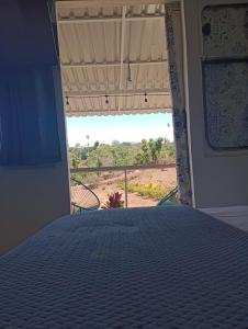 a bedroom with a bed and a view of the desert at The Dreamcatcher Bus in Sarchí