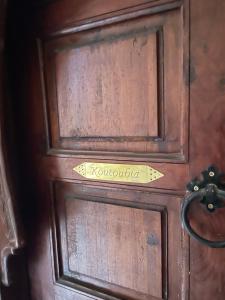 a wooden door with a sign on it at Riad Amalia in Marrakech