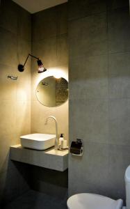 a bathroom with a sink and a toilet at Paliashvili 90 - VAKE Park 2BR Apartment in Tbilisi City