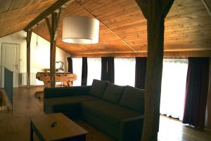 a living room with a couch and a table at Gîte de Magneux - Spa/Jacuzzi in Amions