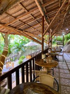 a patio with tables and chairs on a deck at Restaurante, Hostal y Spa Mama Neyumun in El Zaino