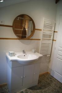 a bathroom with a white sink and a mirror at Gîte de Magneux - Spa/Jacuzzi in Amions