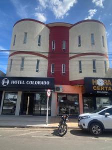 a motorcycle parked in front of a hotel colombia at Hotel Colorado in Vilhena