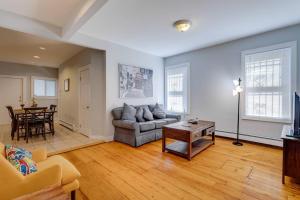a living room with a couch and a table at NEW! Boston Condo Near MBTA, 3Mi to Fenway! (U1) in Boston +8 photos