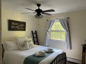 a bedroom with a bed with a ceiling fan at Melvin Village - 5 Bed/3 Bath - Lake Winnipesaukee in Tuftonboro