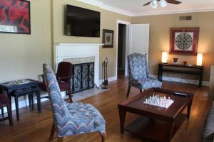 a living room with a table and chairs and a fireplace at 3BR, 2BA Hidden Gem in Midtown/Evergreen district in Memphis