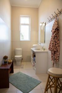 a bathroom with a sink and a toilet at Pianoforte in Swakopmund