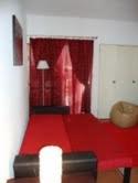 a living room with a red floor and a lamp at Apartamento Ariadna in Albufeira