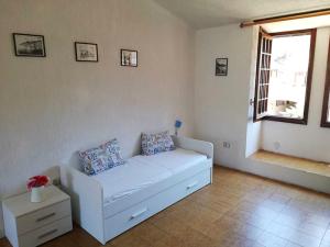 a white couch in a living room with a window at Stella Maris in Campese