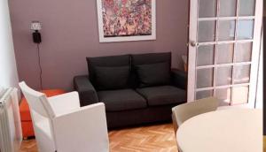 un soggiorno con divano e tavolo di Casa Melé 2, Parking privado opcional a Lleida