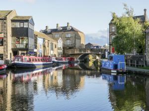 a group of boats on a river in a city at 15 Clitheroe in Skipton