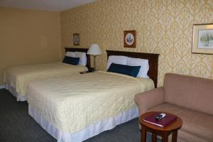 A bed or beds in a room at The Village Inn