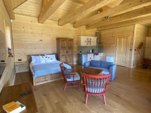 a bedroom with a bed and a table and chairs at Bielańska Ostoja in Uście Gorlickie